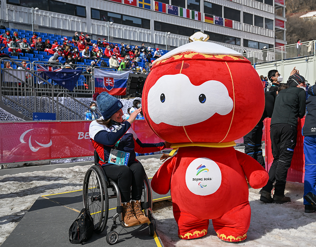 在延慶國家高山滑雪中心，“雪容融”和一位美國代表團成員合影（3月10日攝）。新華社記者 孫非 攝