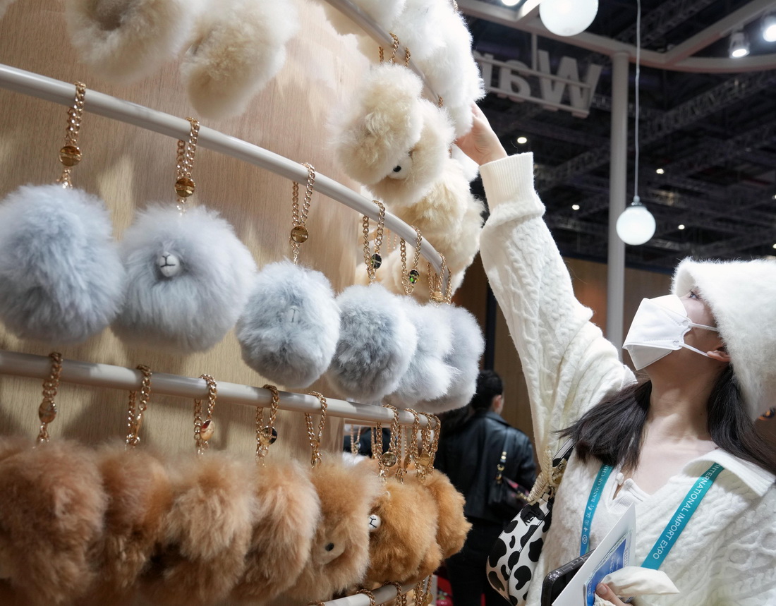 11月8日，參觀者在第五屆進博會“溫暖駝”展臺參觀秘魯羊駝毛掛飾制品。新華社記者 劉穎 攝