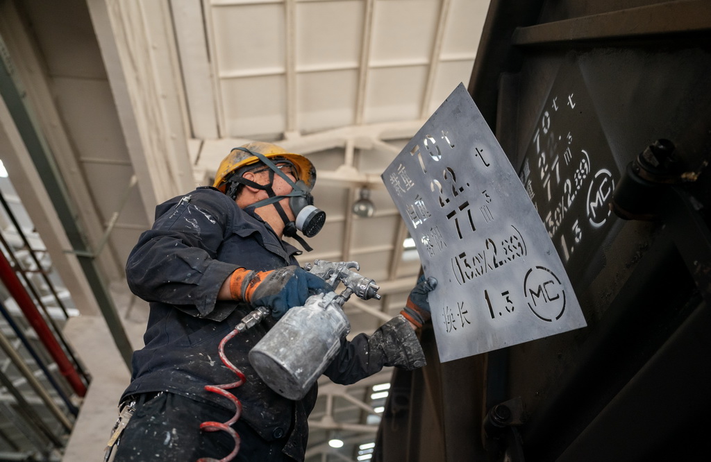 2月1日，張樹紅在給檢修臺位上的一列貨車涂打標識。