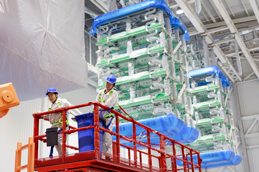 12月19日，在“疆電入渝”特高壓渝北±800千伏換流站工程施工現場，安徽送變電工程有限公司的技術人員在進行國產換流閥的安裝作業。新華社記者 劉潺 攝