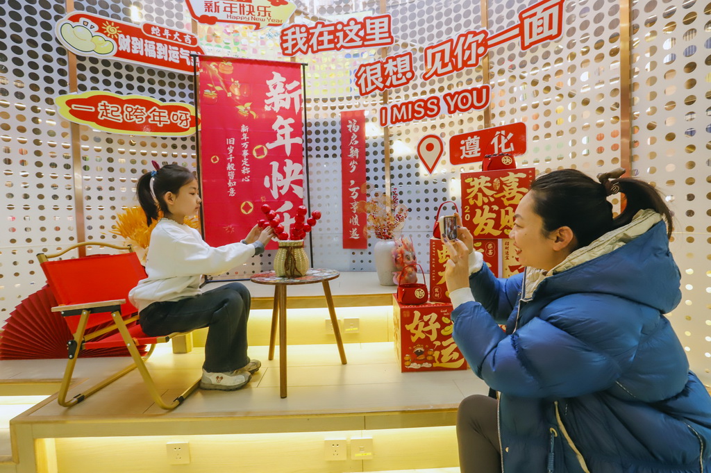 12月29日，家長和小朋友在河北省遵化市新華書店布置的新年打卡點拍照。新華社發（劉滿倉攝）