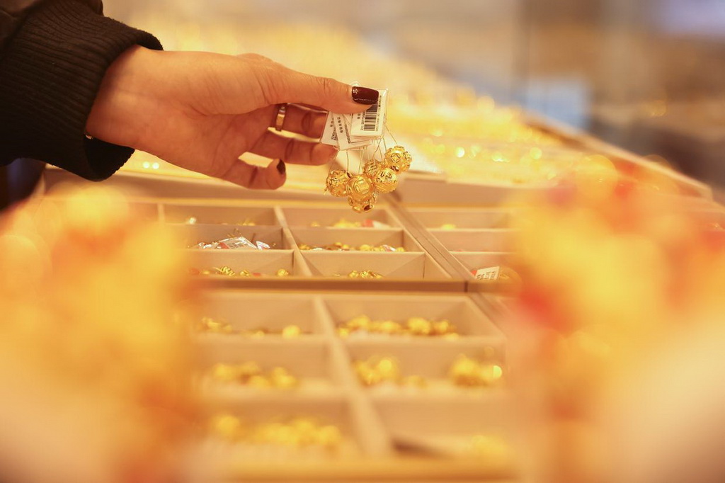 2月11日，在浙江省湖州市德清縣乾元鎮一家金店，店員整理黃金首飾。