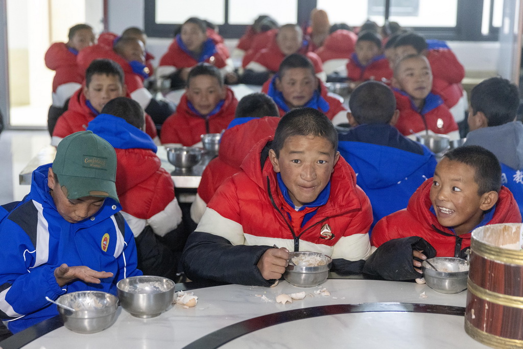 3月5日，來自受災最嚴重的定日縣長所鄉、措果鄉、曲洛鄉的3所小學的學生在定日縣委黨校分流安置點吃早飯。