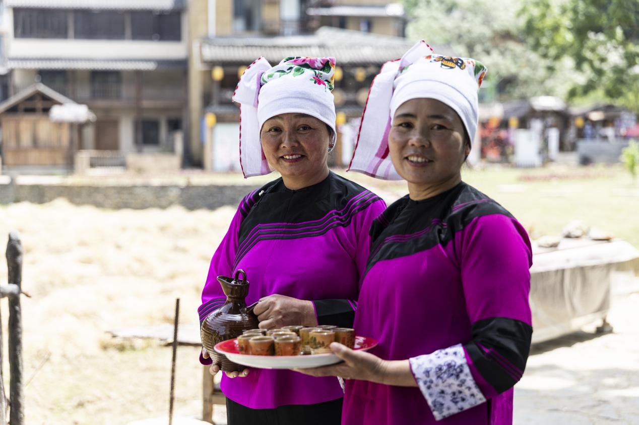 壩美景區里的村民在歡迎游客。王劍攝