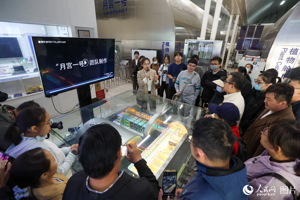 “月宮一號”團隊的成員正在為觀眾講解介紹“月宮一號”科普基地相關信息。