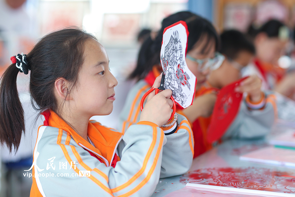  2025年5月17日，在陜西省旬邑縣實驗中學，學生展示剪紙作品。