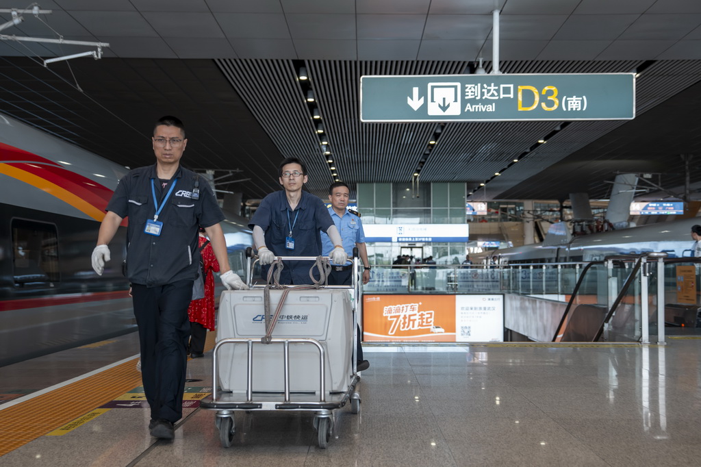 7月1日，武漢站工作人員將專用寵物運輸箱運送至站臺。