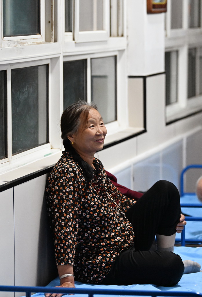 7月29日，一位老人在天津市薊州區下營鎮初級中學休息。