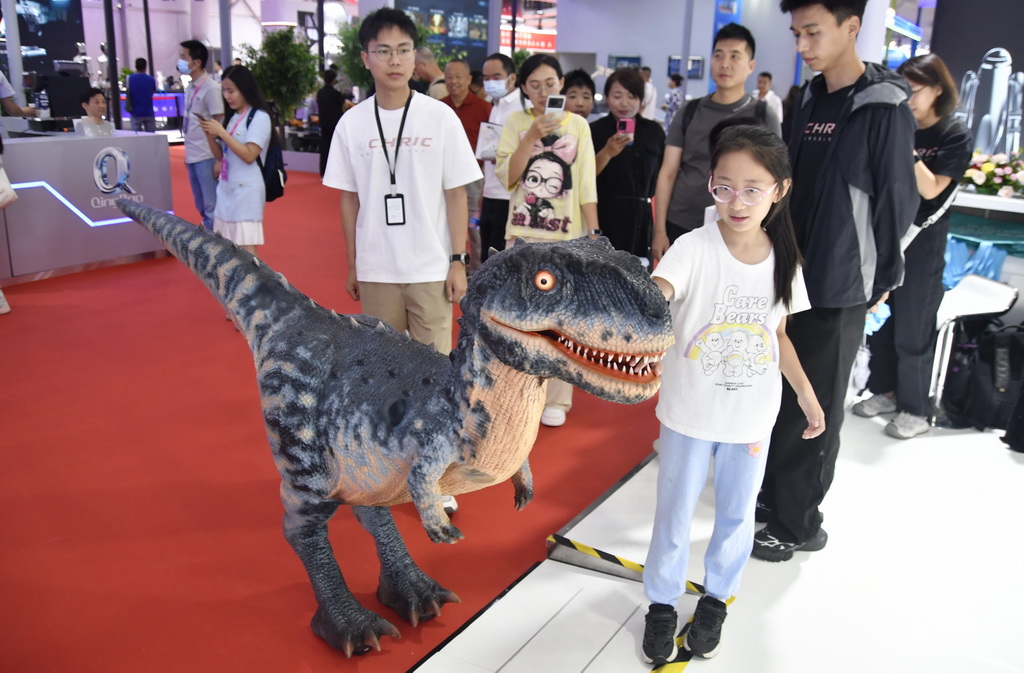 8月8日，觀眾在2025世界機器人大會現場與展出的仿真恐龍互動。新華社記者 李欣 攝