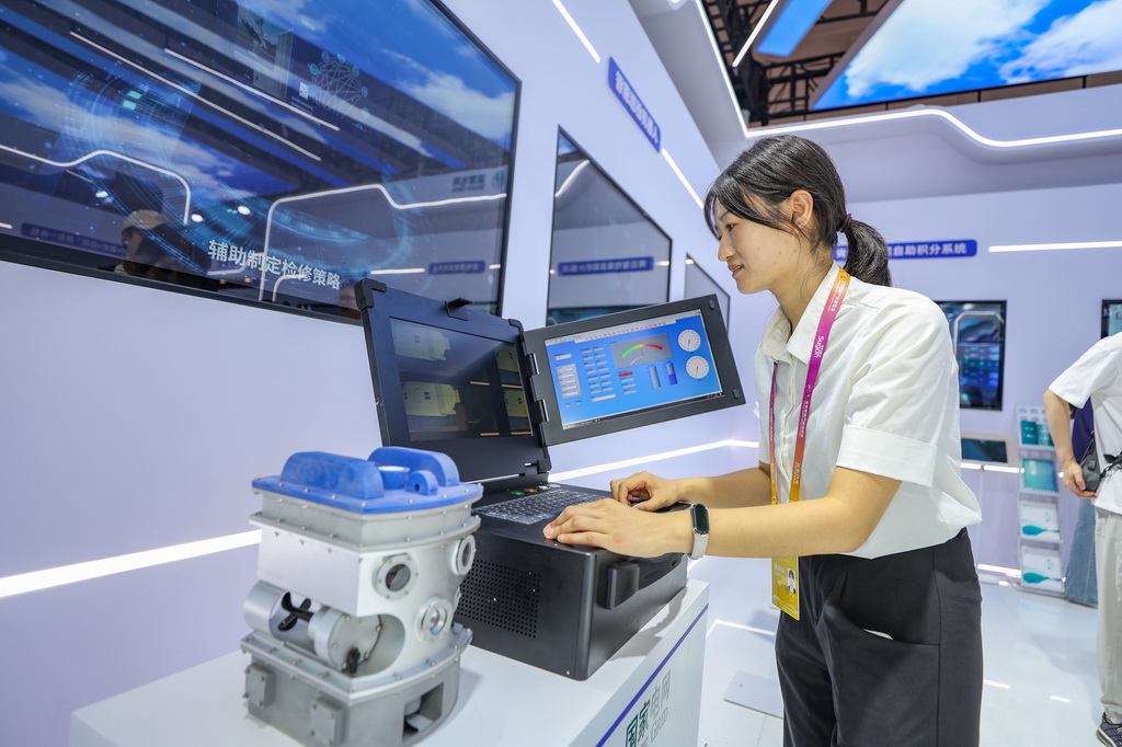 9月5日，在2025世界智能產業博覽會現場，國家電網展廳工作人員展示“大型變壓器內部智能巡檢機器魚”。新華社記者 黃偉 攝