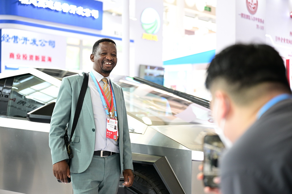 9月8日，嘉賓在投洽會特斯拉展臺前留影。