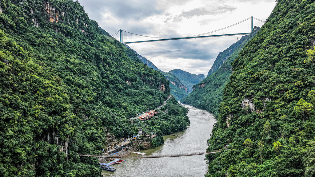 景區內的索道橋與遠處的花江峽谷大橋遙相呼應（9月27日攝，無人機照片）。