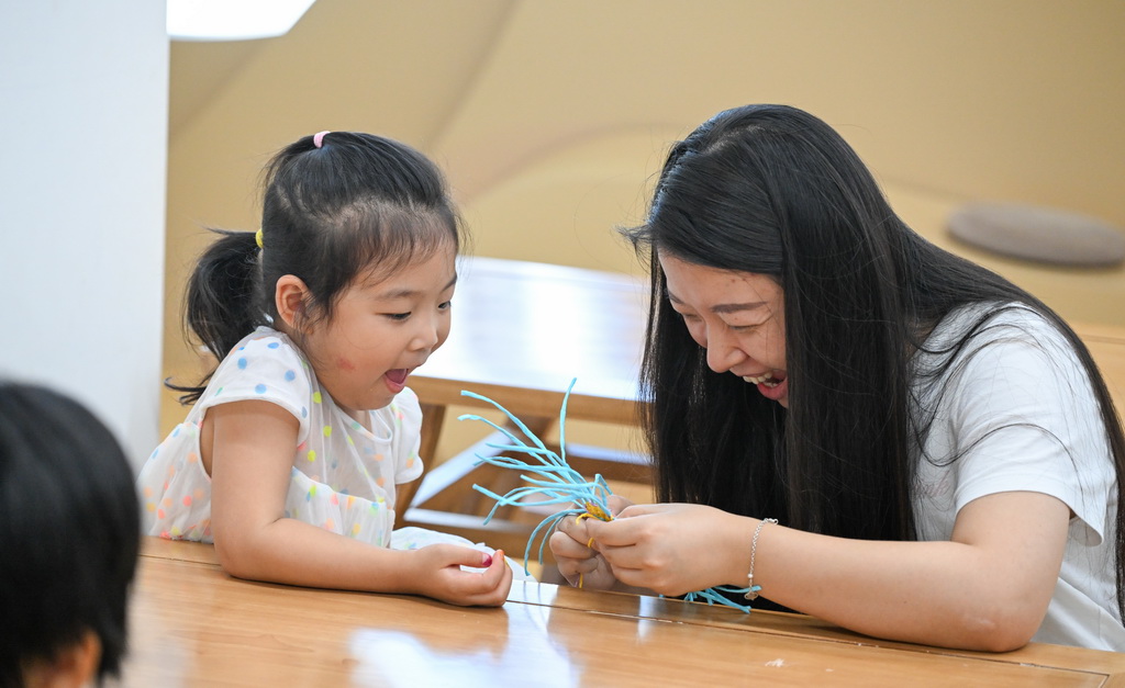 10月12日，在海南省文化館，家長和小朋友學習東山草編技藝。